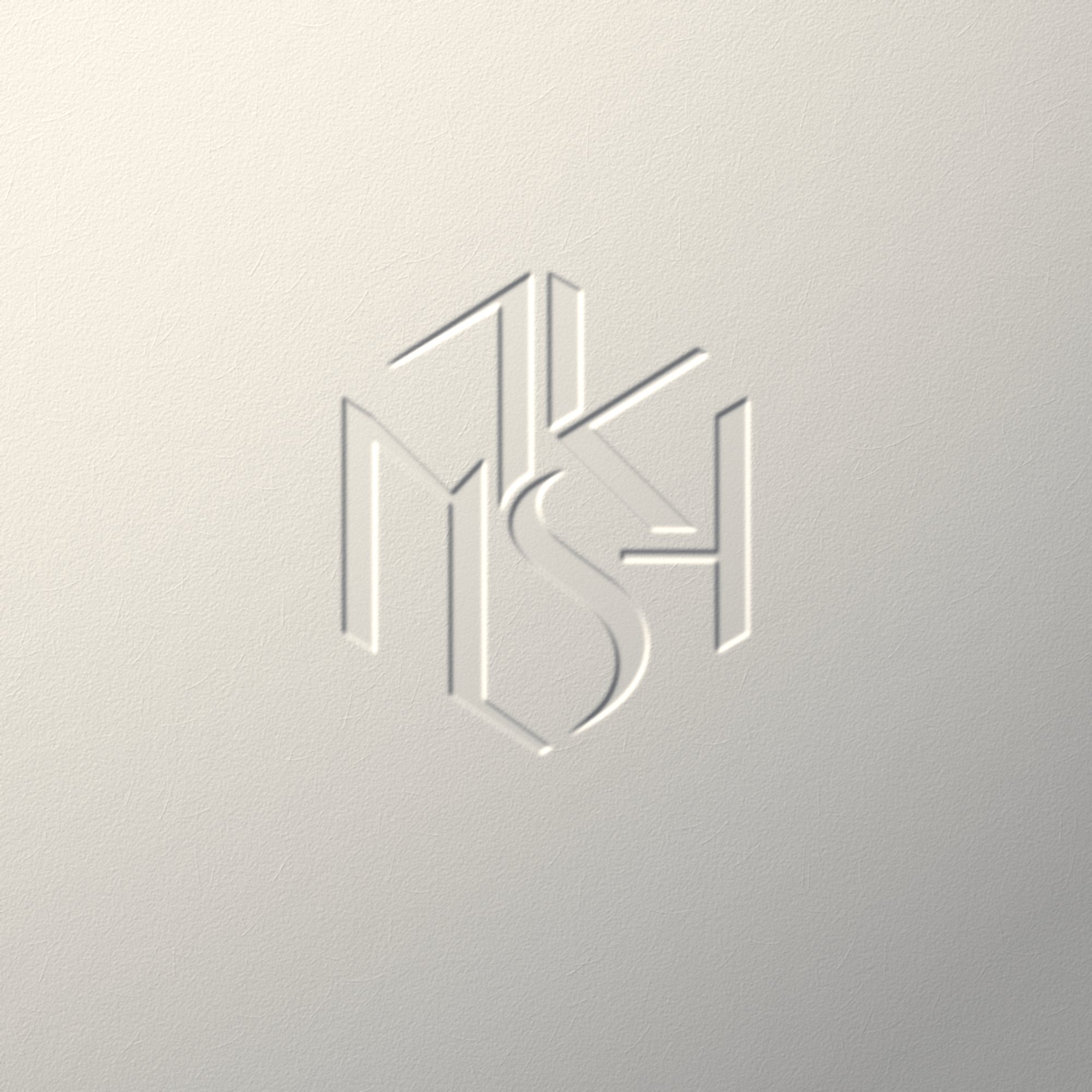 The MKSH monogram debossed on paper